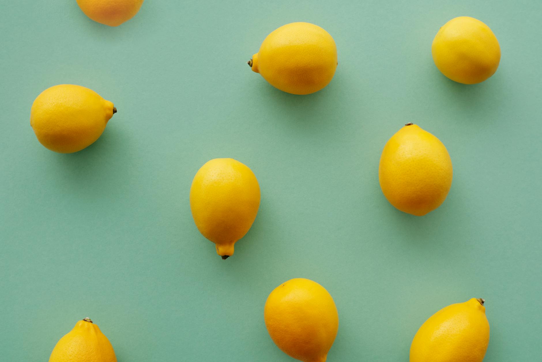 Bright yellow lemons on a pastel green background, symbolizing fresh starts and reclaiming intimacy
