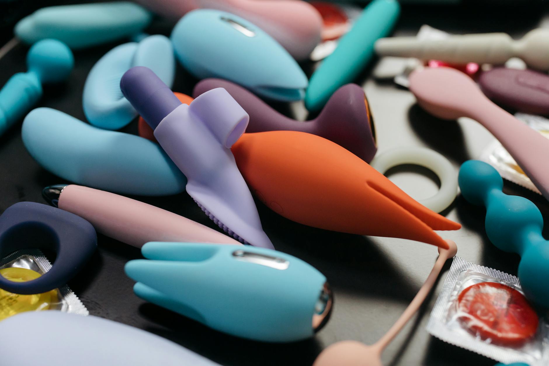 Woman holding a blue silicone vibrator in a safe, contemplative moment