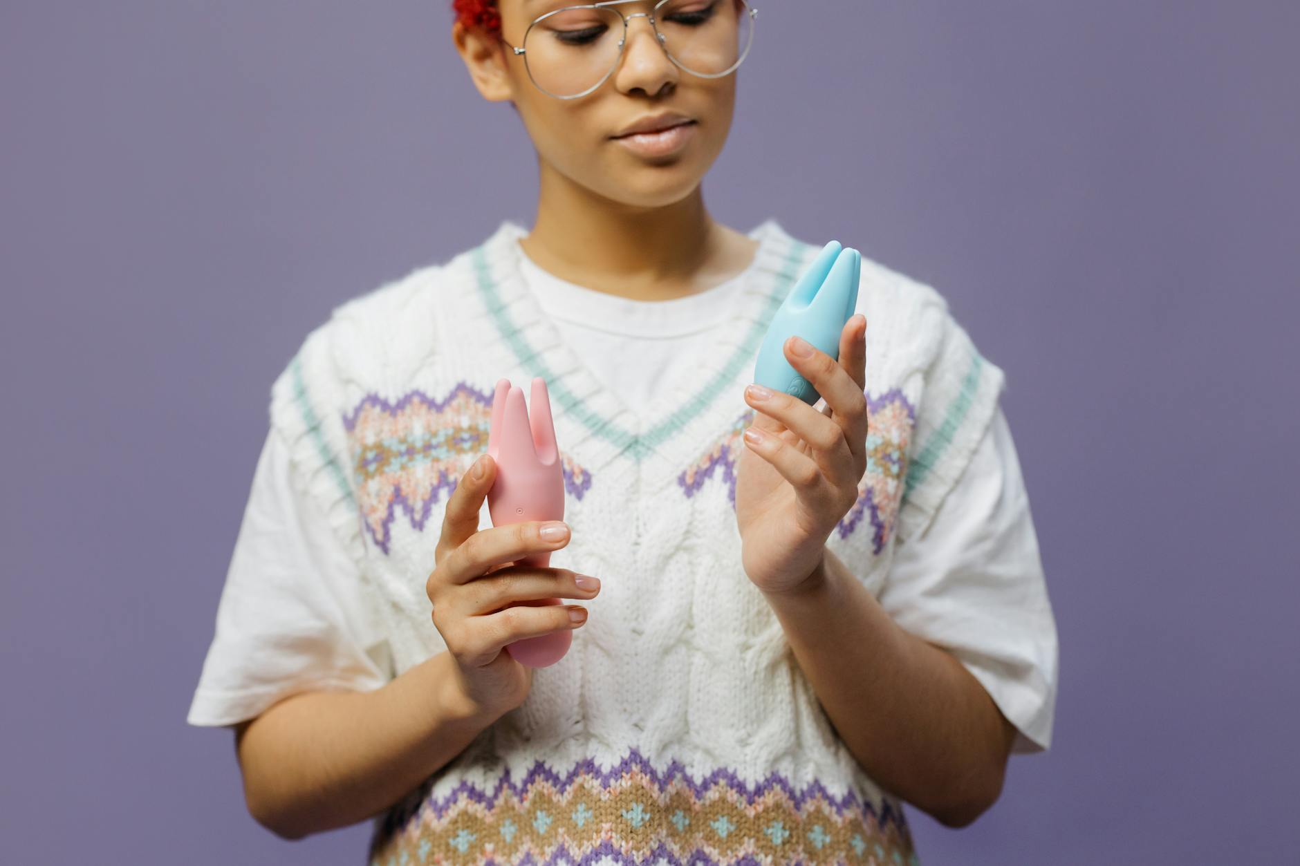 Woman holding blue and pink silicone vibrators, representing different arousal tools for variable desire